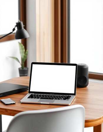 Mockup image of laptop with blank white screen on wooden table in modern office