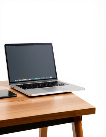 Laptop computer with blank screen on wooden table isolated on white background