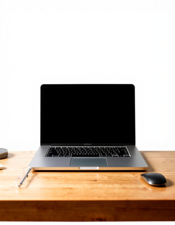 Laptop computer with blank screen on wood table isolated on white background