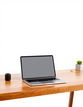 Laptop with blank screen on wooden table isolated on white background.