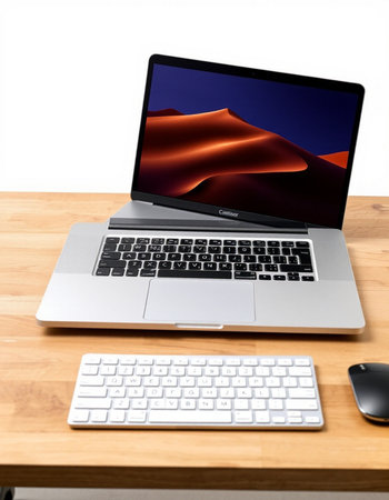 Laptop on a wooden table with a keyboard and mouse on a white background