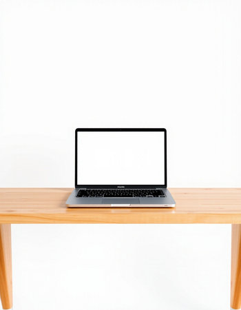 Laptop computer with blank screen on wooden desk isolated on white background