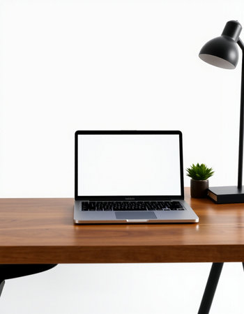 Laptop with blank screen on wooden table and lamp on white backgroundの写真素材