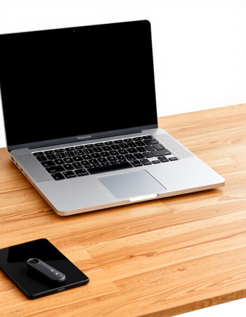 Laptop and mobile phone on wooden desk isolated on white background.