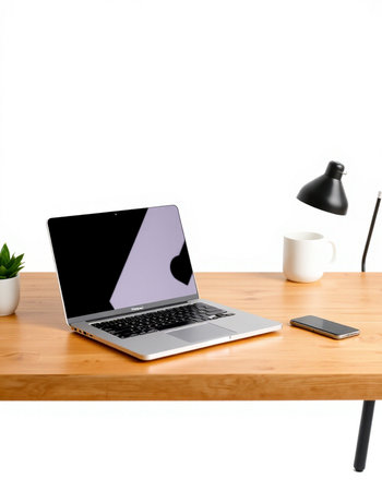 Laptop with blank screen on wooden table isolated on white background.