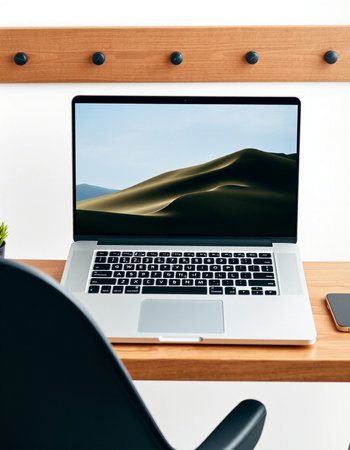 Laptop with empty screen on wooden shelf in modern office. Mock up
