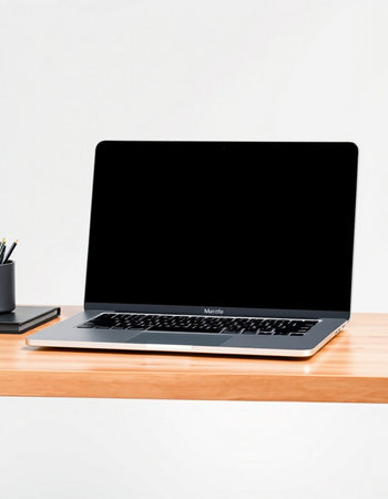 Laptop computer with blank screen on wooden table isolated on white background