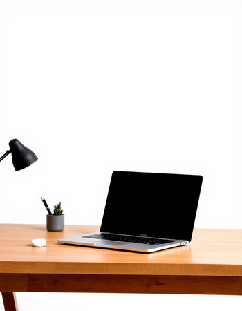 Laptop with blank screen on wooden desk isolated on white background.
