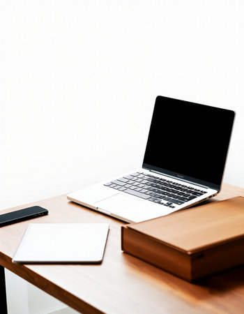 Laptop computer with blank screen on wooden desk in office, stock photoの写真素材
