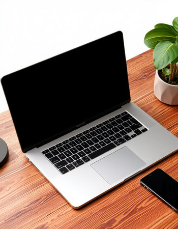 Laptop with blank screen on wooden table, work from home concept