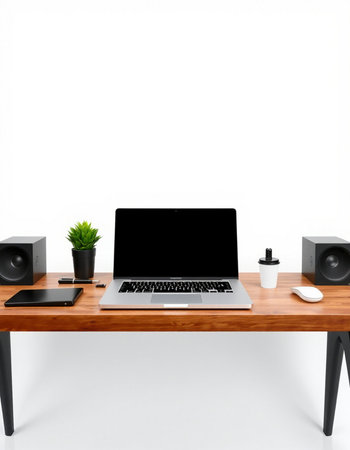 Modern workspace with laptop, coffee cup and speaker on white background.の写真素材
