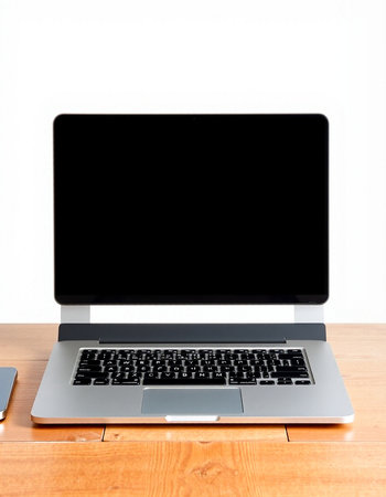Laptop computer with blank screen on wooden desk isolated on white background