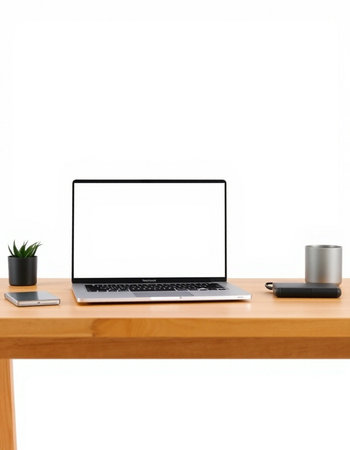 Office desk with blank screen laptop computer and stationery on white background