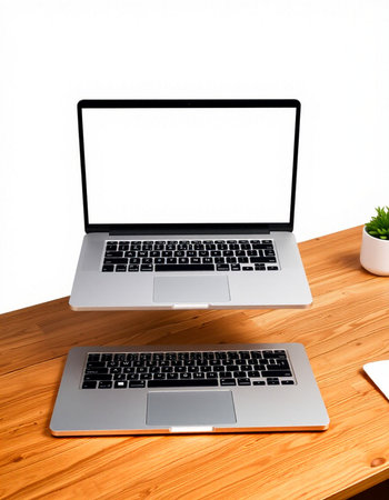 Laptop computer with blank screen on wooden table isolated on white background