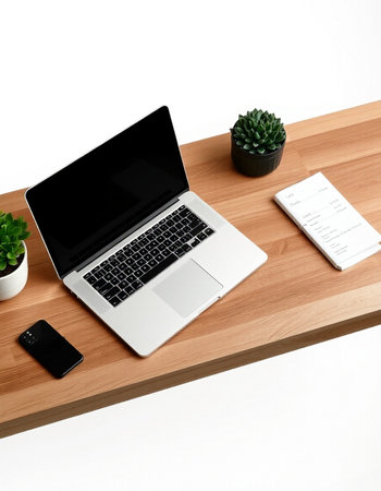 Laptop and notebook on wood table with white background, work space