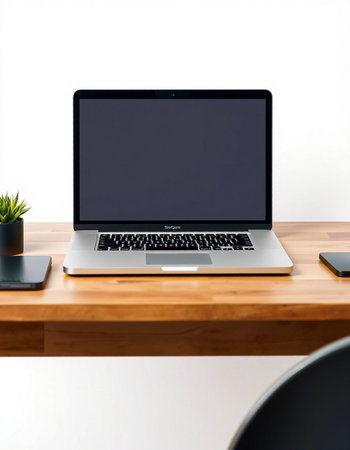 Laptop with blank screen on wooden desk in office, stock photo