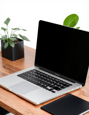 Laptop with blank screen on wooden table in modern office, stock photo