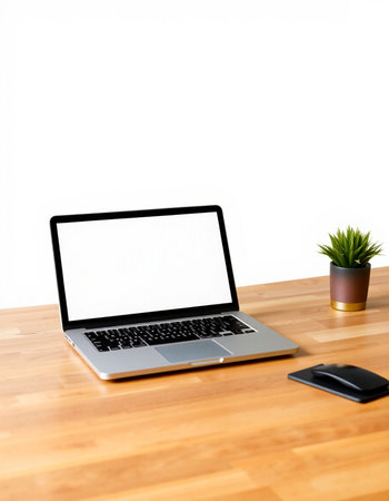 Laptop computer with blank screen on wood table and white wall background