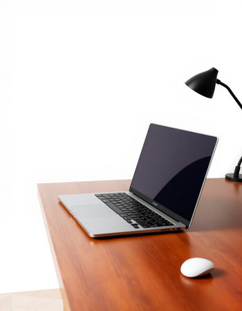 Laptop and mouse on the desk isolated on a white background.