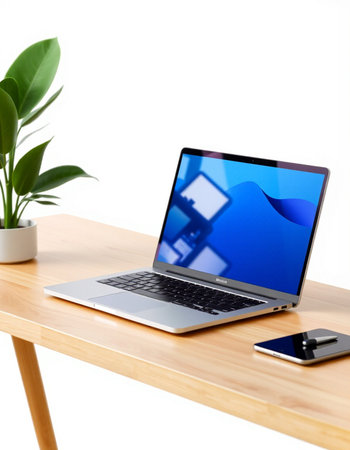laptop on wooden table with smart phone and plant isolated on white background