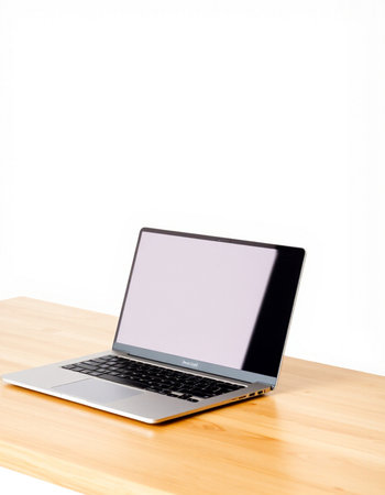 Laptop with blank screen on wooden table isolated on white background.