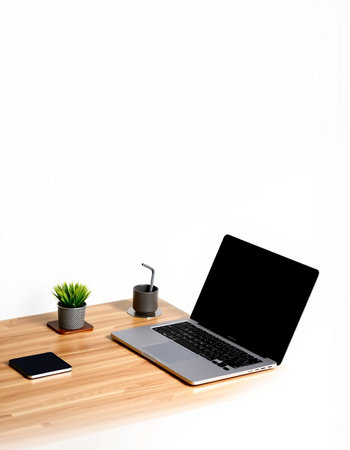 Modern workspace with blank screen laptop computer, coffee cup, smart phone and plant on wood table...