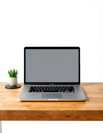 Laptop computer on wooden table with white wall background, stock photo
