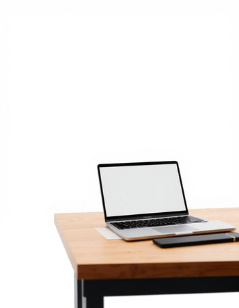 Laptop computer with blank screen on wooden table isolated on white backgroundの写真素材
