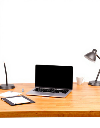 Laptop with blank screen on wooden table and white wall background.
