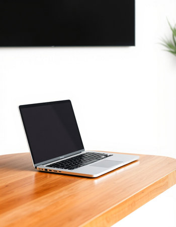 Laptop on a wooden table in the living room, stock photo