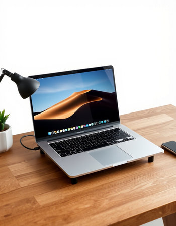 Laptop on a desk with a picture of the sand dunes