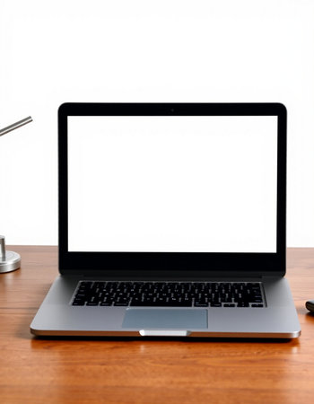Laptop computer with blank screen on wooden desk isolated on white background