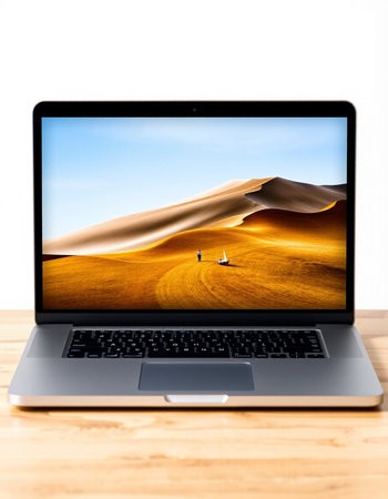 Laptop with sand dunes on screen, isolated on white background