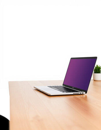 Laptop with blank purple screen on wooden desk isolated on white background