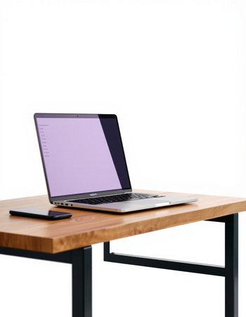 Laptop on wooden table isolated on white background with clipping path.の写真素材