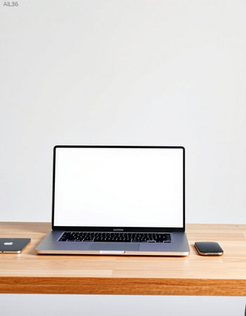 Laptop with blank screen on wooden table and white wall background.の写真素材