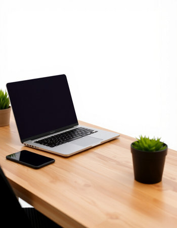 Laptop with blank screen on wooden table with white wall background.の写真素材