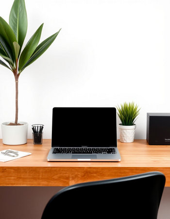 Laptop with blank screen on wooden desk in office, stock photoの写真素材