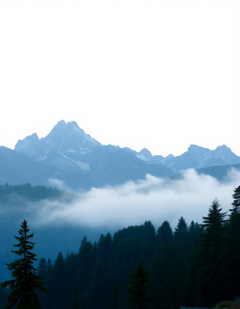 Mountains in the fog on a background of blue sky and clouds