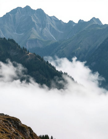 Mountain landscape in the clouds. View from the top of the mountain.の写真素材