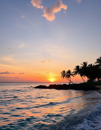Beautiful sunset on the beach with palm trees and sea waves.