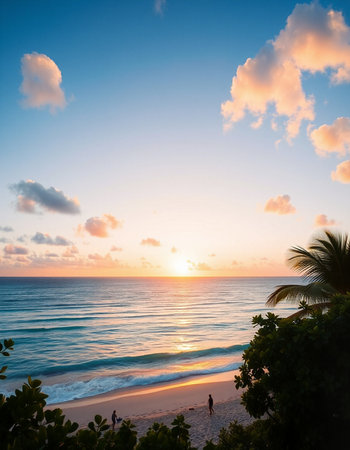 Beautiful sunset on the beach with palm trees and blue sky.