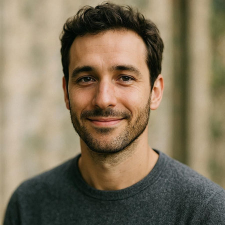 Portrait of a handsome man with a beard and mustache smiling at the camera