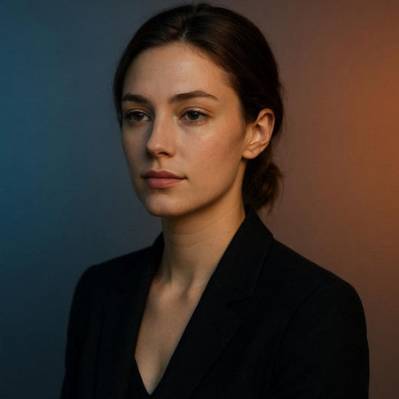 Portrait of a beautiful young woman in a black suit on a dark background