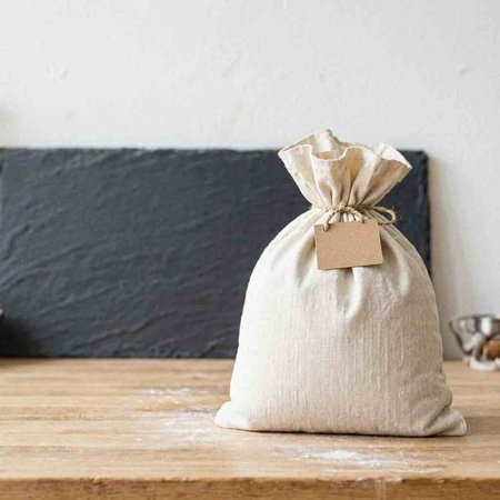 Bag of flour on a wooden table. Rustic style.