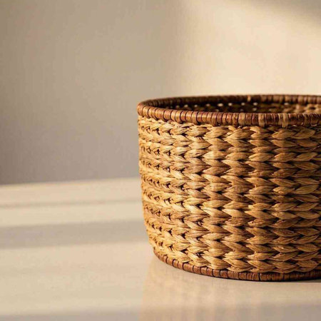 Wicker basket on a white table against the background of a wall