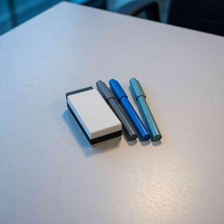 Three pens in a row on a white table. High quality photo
