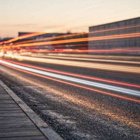 Night traffic light trails on the road. Long exposure photo. Blurred background.