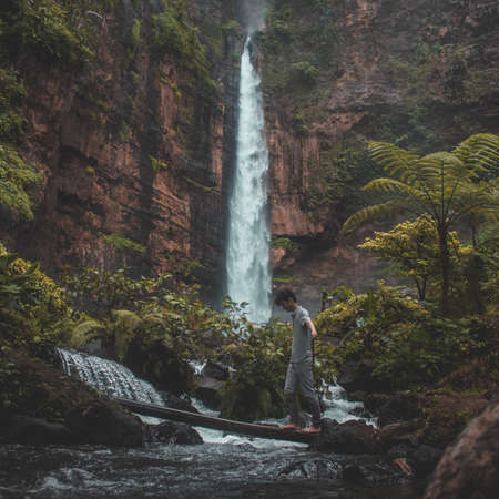 The man walk from one side to another side with âtree bridgeâ 
Shot at Kapas Biru waterfall, east Javaの写真素材