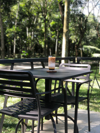 Coffee cup on table in coffee shop with nature background.
